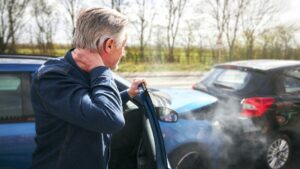 Man stepping out of a car after rear-ending another vehicle.