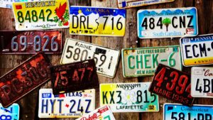 A wall of license plates with different colors and designs.