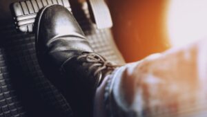 A foot stepping on a car brake