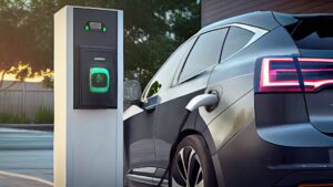 An electric car parked and charging at an EV charging station.