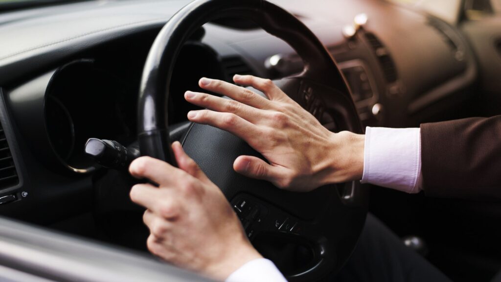 A man honking his car horn.