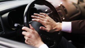 A man honking his car horn.