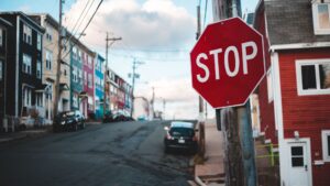 A stop sign at a residential intersection.
