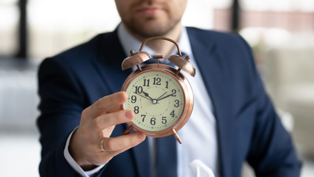 A man holding a clock.