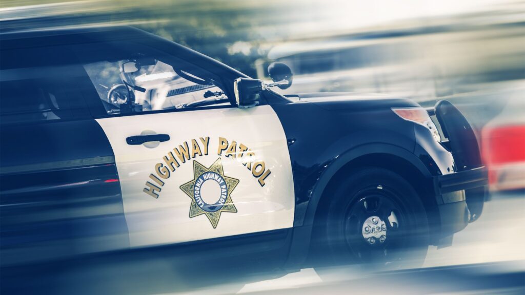 A California Highway Patrol Van speeding through the road.