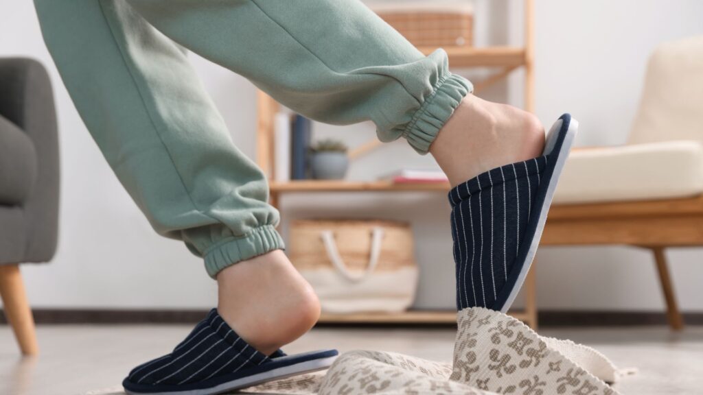 A person tripping from a loose rug in a home.