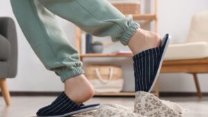 A person tripping from a loose rug in a home.