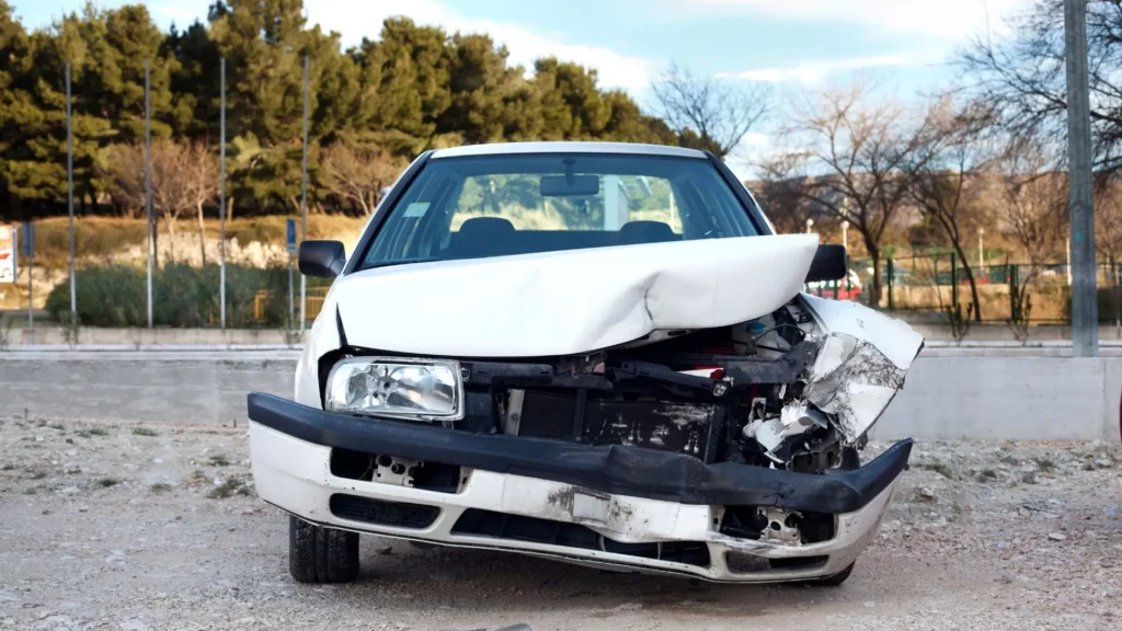 A white car with a totaled front.