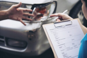 Insurance agent working during on site car accident claim process