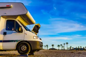 A broken RV in the middle of the desert.