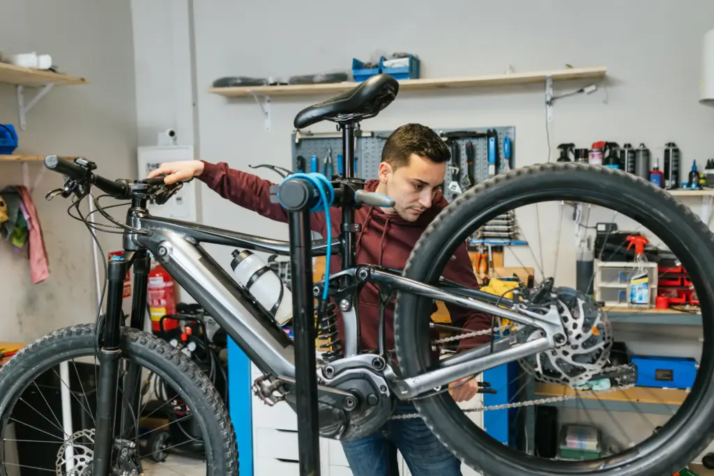 A man modifying an electric bike.