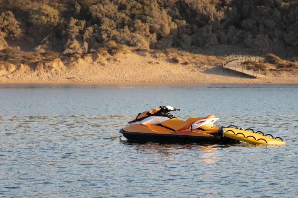 A yellow jet ski stranded in the middle of a lake.