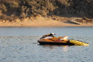 A yellow jet ski stranded in the middle of a lake.